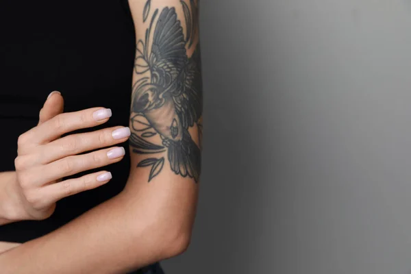 Woman Applying Cream Her Arm Tattoos Light Grey Background Closeup — Foto Stock