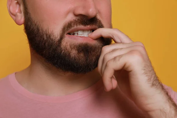 Man Biting His Nails Yellow Background Closeup Bad Habit — Stock Photo, Image