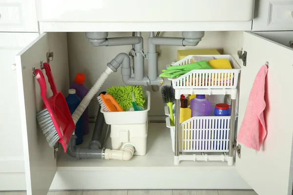 Different Cleaning Tools Supplies Open Cabinet Sink — Zdjęcie stockowe