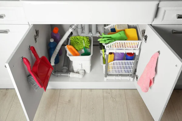 Different Cleaning Tools Supplies Open Cabinet Sink — Zdjęcie stockowe