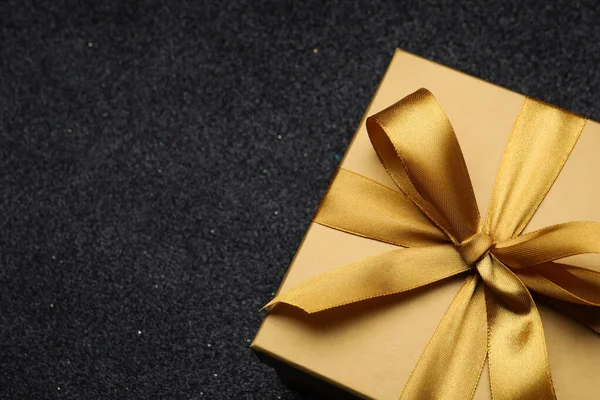 Golden Gift Box Satin Bow Black Background Closeup Space Text — Fotografia de Stock