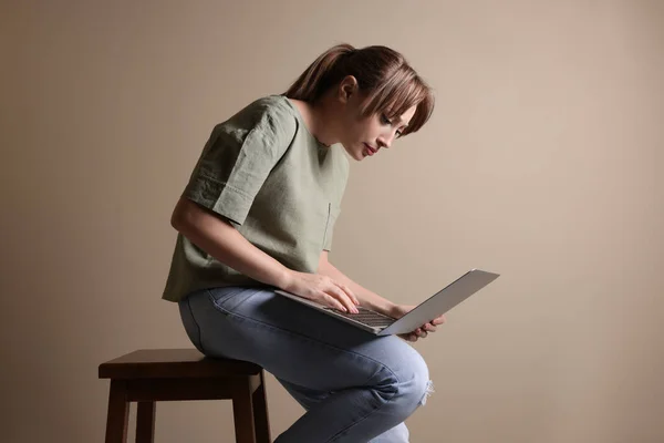 Jovem Com Postura Usando Laptop Enquanto Sentado Fezes Contra Fundo — Fotografia de Stock