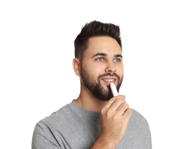 Young Man Applying Lip Balm White Background — Stock Photo, Image
