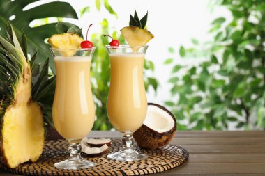 Lezzetli Pina Colada kokteylleri ve ahşap masa malzemeleri, metin için yer