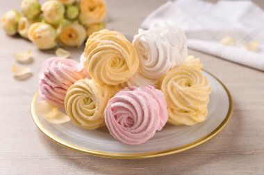 Ahşap masada bir sürü lezzetli marşmelov tabağı.