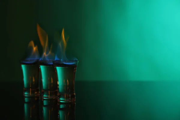Flammande Vodka Shotglasögon Grön Bakgrund Utrymme För Text — Stockfoto