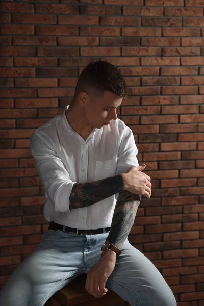 Young Man Tattoos Sitting Stool Brick Wall — Stock Photo, Image