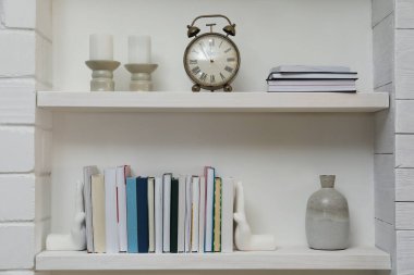 Kitaplı el şekilli kitap desteleri ve kapalı alandaki raflarda dekorasyon. İç tasarım