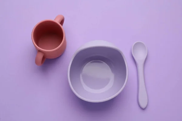紫色の背景にプラスチック食器のセット フラットレイ ベビーフードの提供 — ストック写真