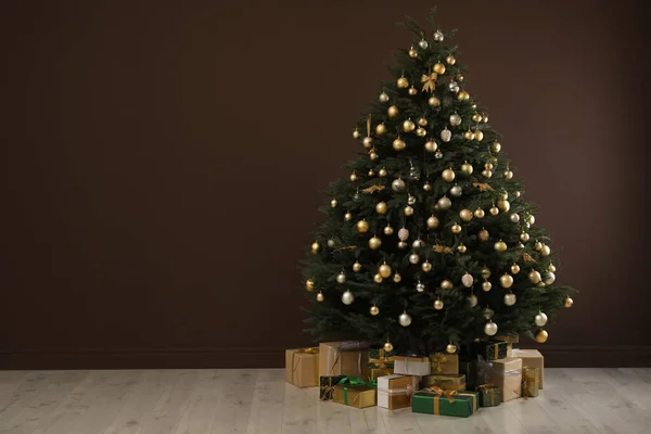 Árvore Natal Lindamente Decorada Muitas Caixas Presente Perto Parede Marrom — Fotografia de Stock