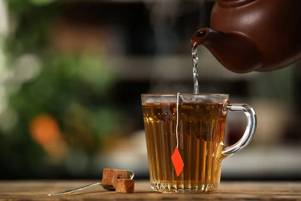 Pouring Hot Water Glass Cup Tea Bag Wooden Table Blurred — Stock Photo, Image