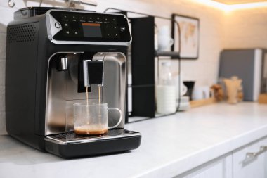Modern kahve makinesi mutfakta espresso yapıyor, metin için yer var.