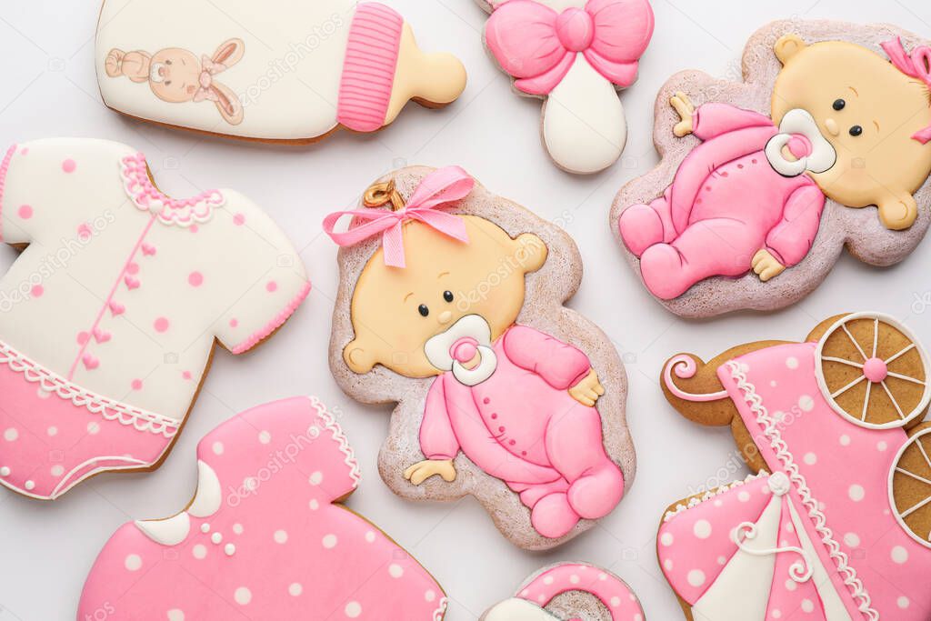Cute tasty cookies of different shapes on white background, top view. Baby shower party