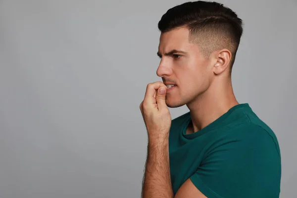 Man Biting His Nails Grey Background Space Text Bad Habit — Fotografia de Stock