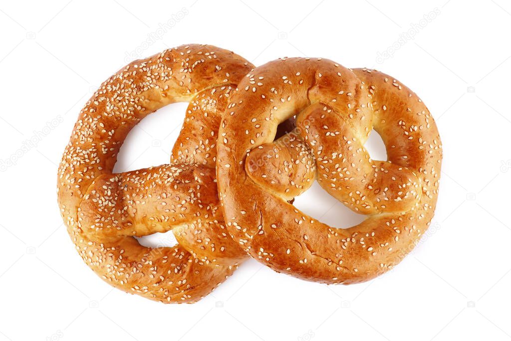 Tasty freshly baked pretzels on white background, top view