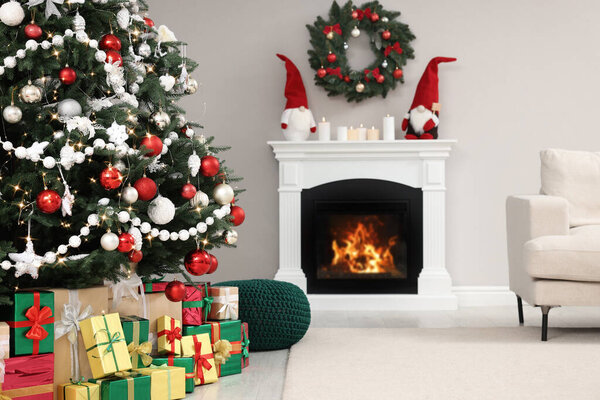 Beautiful Christmas tree and many gift boxes in stylish living room interior