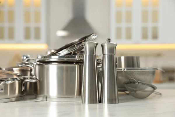 Set Shiny Cooking Utensils White Table Blurred Background — Stock Photo, Image