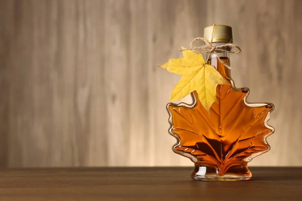 Leaf Shaped Bottle Tasty Maple Syrup Wooden Table Space Text — Stock Photo, Image
