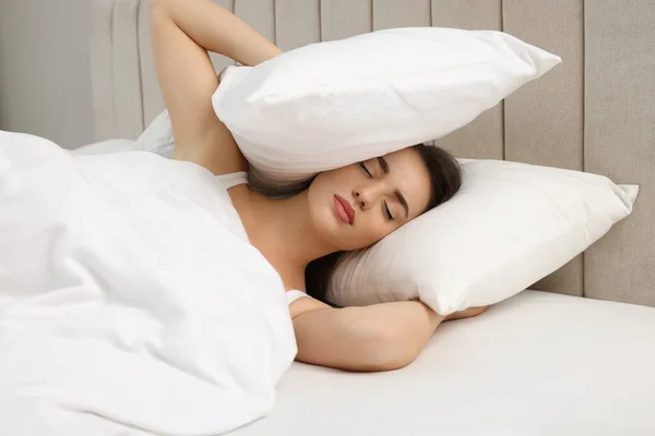 Unhappy Young Woman Covering Ears Pillows Bed — Stock Photo, Image