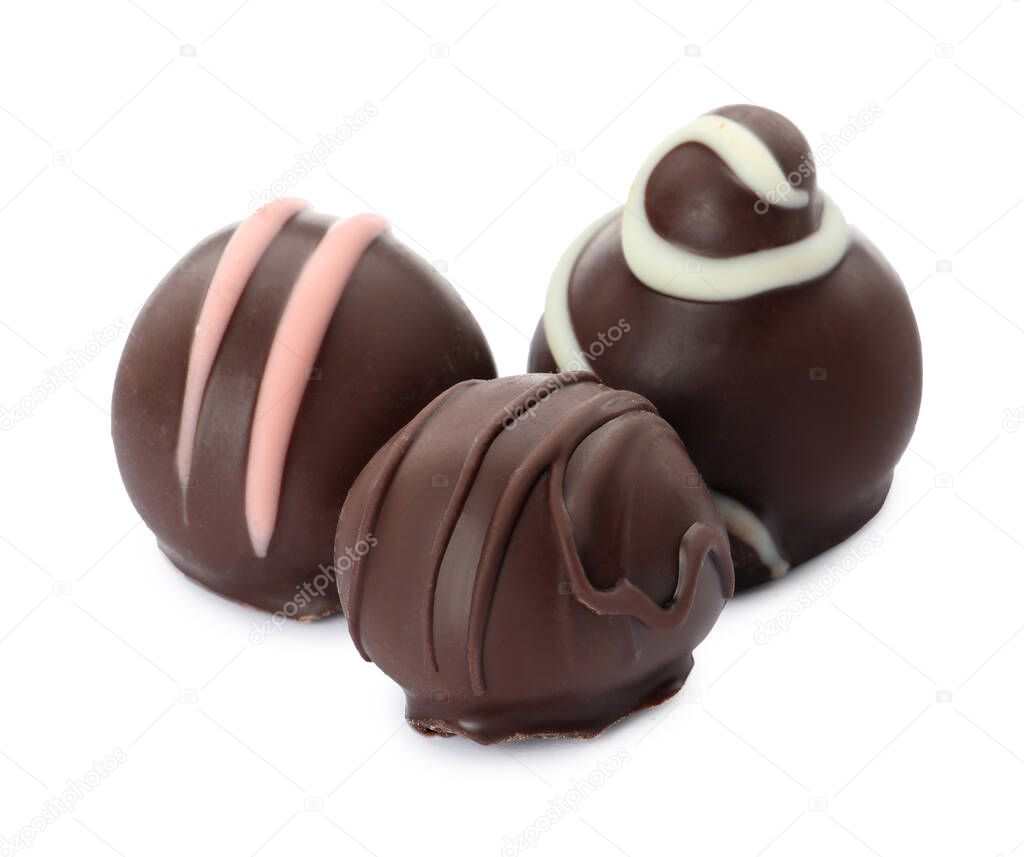 Many different delicious chocolate truffles on white background