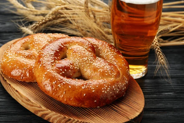 Tasty Pretzels Glass Beer Wheat Spikes Black Wooden Table — Stock Photo, Image