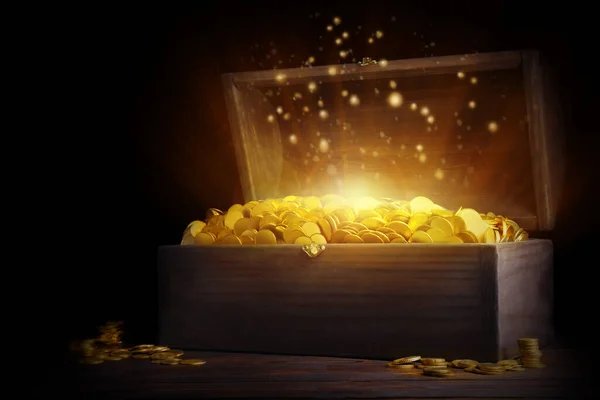 黒を背景に木製のテーブルの上に金のコインとオープン宝箱 — ストック写真
