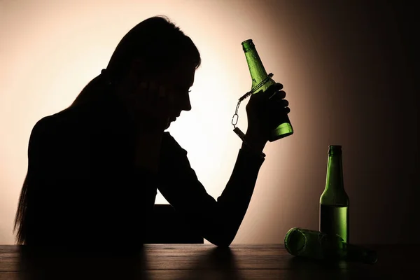 Alcohol Addiction Silhouette Woman Handcuffed Beer Bottle Wooden Table Backlit — Stock Photo, Image