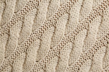 Arka plan olarak güzel desenli bej örülmüş kumaş, üst görünüm