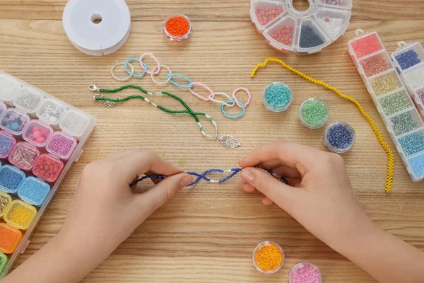 Girl Making Beaded Jewelry Wooden Table Top View — Stock Photo, Image