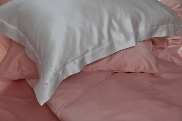 Closeup view of bed with beautiful silk linens