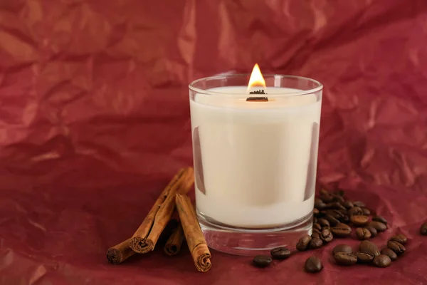 Burning Soy Candle Cinnamon Sticks Coffee Beans Crumpled Red Paper — Stock Photo, Image