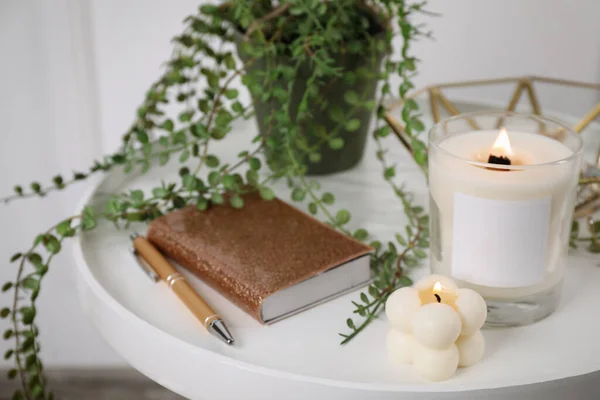 Burning Candles Notebook Houseplant White Wooden Table Indoors — Stock Photo, Image