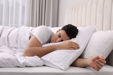 Evde yastığın altında uyuyan yakışıklı adam.