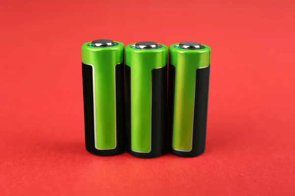 Neue Batterien Auf Rotem Hintergrund Nahaufnahme — Stockfoto