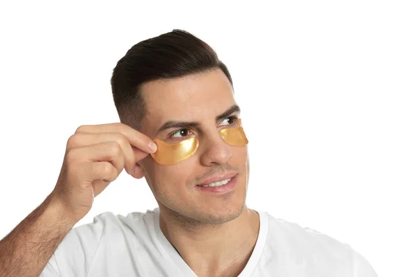 Man Applying Golden Eye Patch White Background — Stock Photo, Image