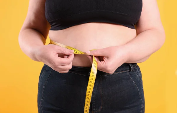 Overweight Woman Measuring Waist Tape Yellow Background Closeup — Stock Photo, Image