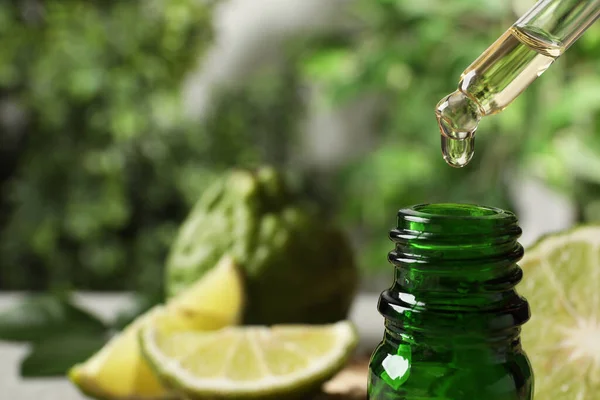 Dripping Bergamot Essential Oil Glass Bottle Blurred Background Closeup — Stock Photo, Image