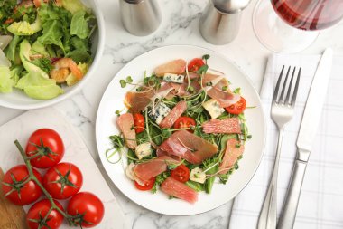 Delicious pomelo salad with prosciutto served on white marble table, flat lay clipart