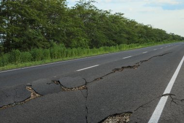 Depremden sonra asfalt yolda büyük çatlaklar oluştu.