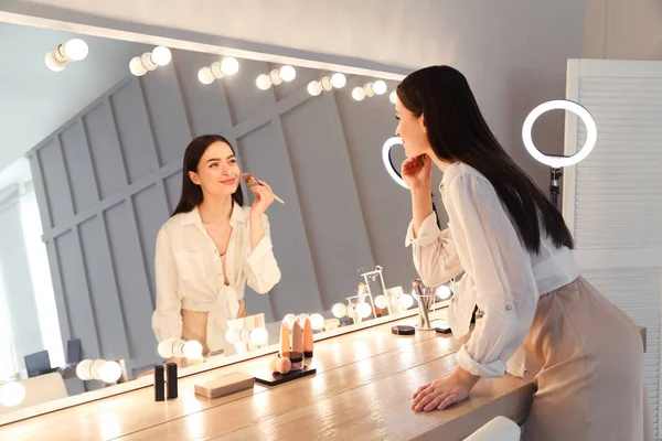 Jeune Femme Appliquant Maquillage Près Miroir Éclairé Intérieur — Photo