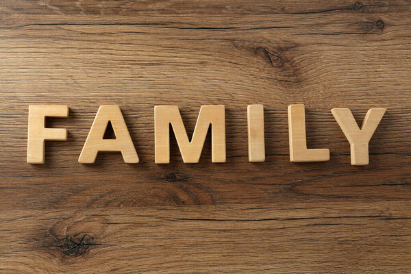 Word Family made with wooden letters on table, flat lay