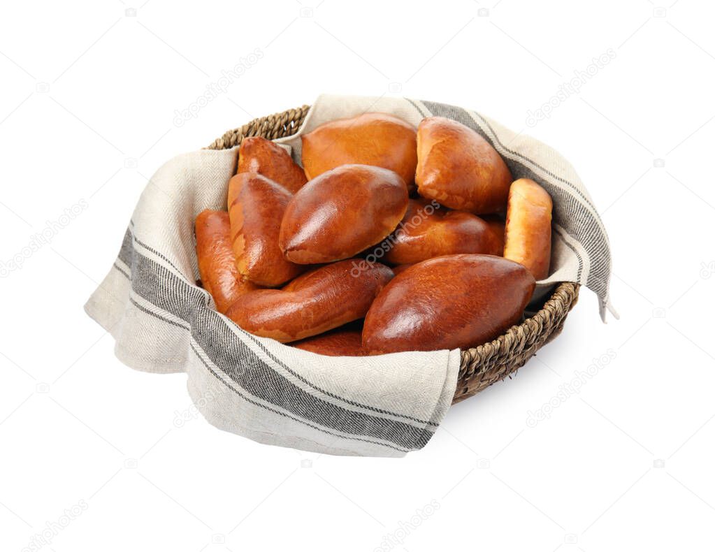 Wicker basket with delicious baked pirozhki on white background