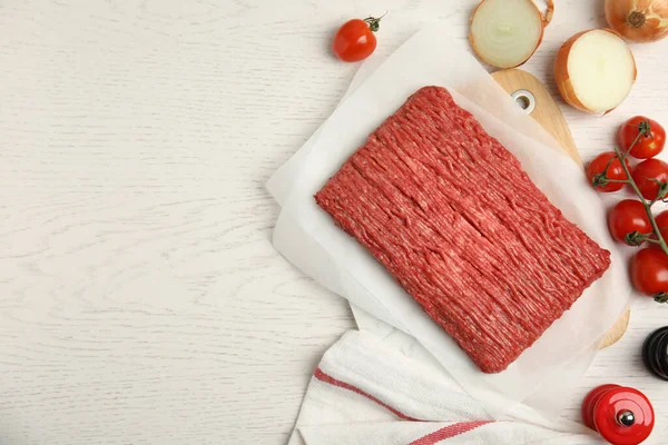 stock image Raw fresh minced meat and other ingredients on white wooden table, flat lay. Space for text