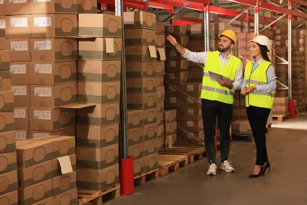 Manager and worker at warehouse. Logistics center