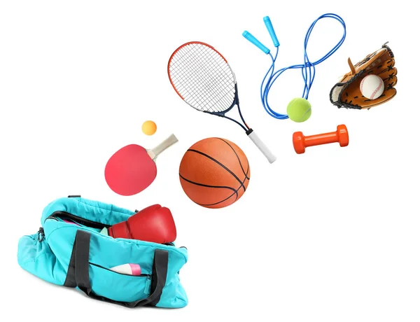 Sports bag and different gym stuff flying on white background