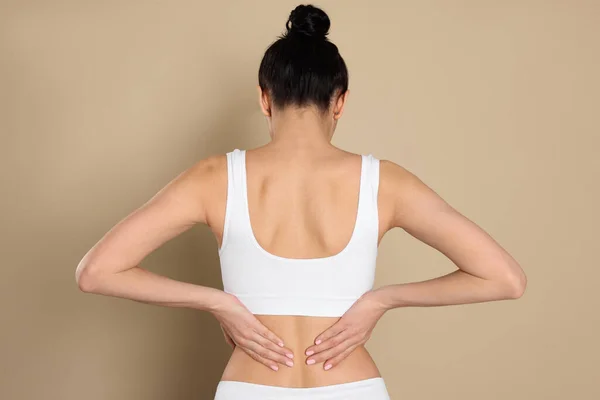 Woman Suffering Pain Back Beige Background — Stock Photo, Image