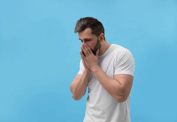 Man Sneezing Light Blue Background Cold Symptoms — Stock Photo, Image