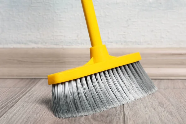 Sweeping Wooden Floor Plastic Broom Closeup — Stock Photo, Image