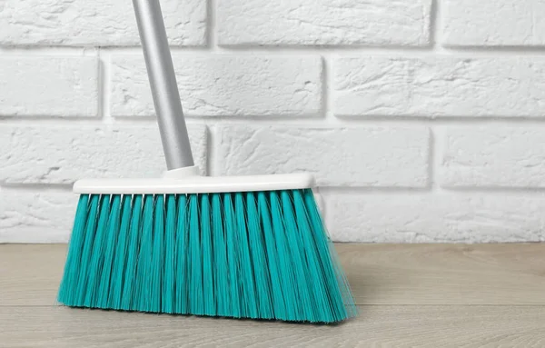 Plastic Broom White Brick Wall Indoors — Stock Photo, Image