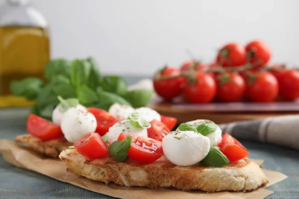 Delicious Sandwiches Mozzarella Fresh Tomatoes Basil Blue Wooden Table Space — Stock Photo, Image